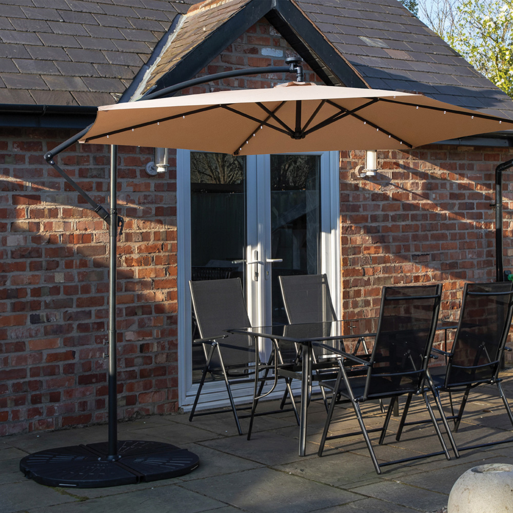 Samuel Alexander 4 Seater Glass Top Outdoor Dining Set with Beige Banana Lit Parasol and Base Image 1
