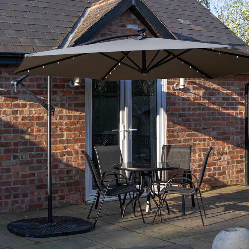Samuel Alexander 4 Seater Glass Top Stackable Dining Set with Grey Banana Lit Parasol and Base Image 1