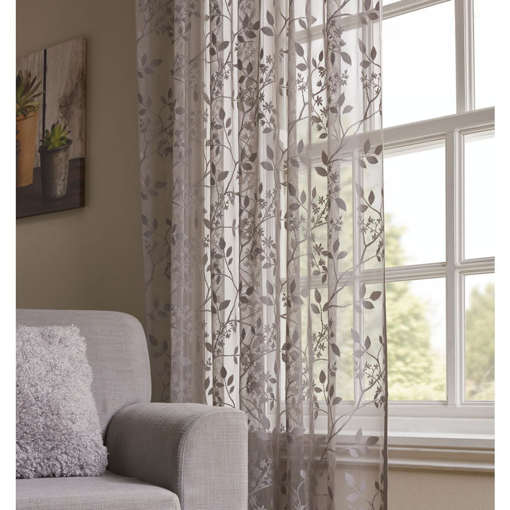 Wilko Grey Floral Slot Top Voile 145 W x 137cm D Create privacy in your living space, without losing light, with our lace voile. The soft grey net curtain features a delicate pattern for an elegant feel. The ready-made voile panel can be fitted to a curtain pole with ease.  Washing instructions: Hand wash only. Always read the label. Wilko Grey Floral Slot Top Voile 145 W x 137cm D