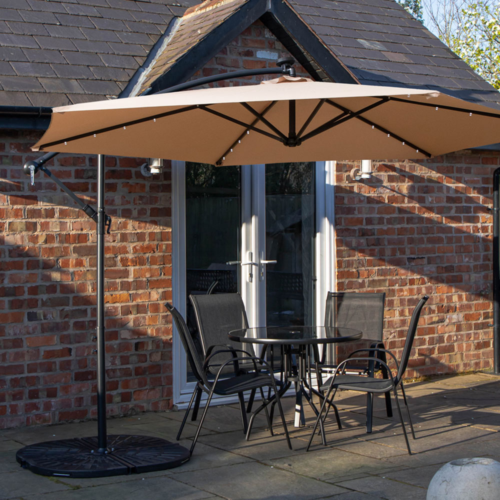 Samuel Alexander 4 Seater Glass Top Stackable Dining Set with Beige Banana Lit Parasol and Base Image 1