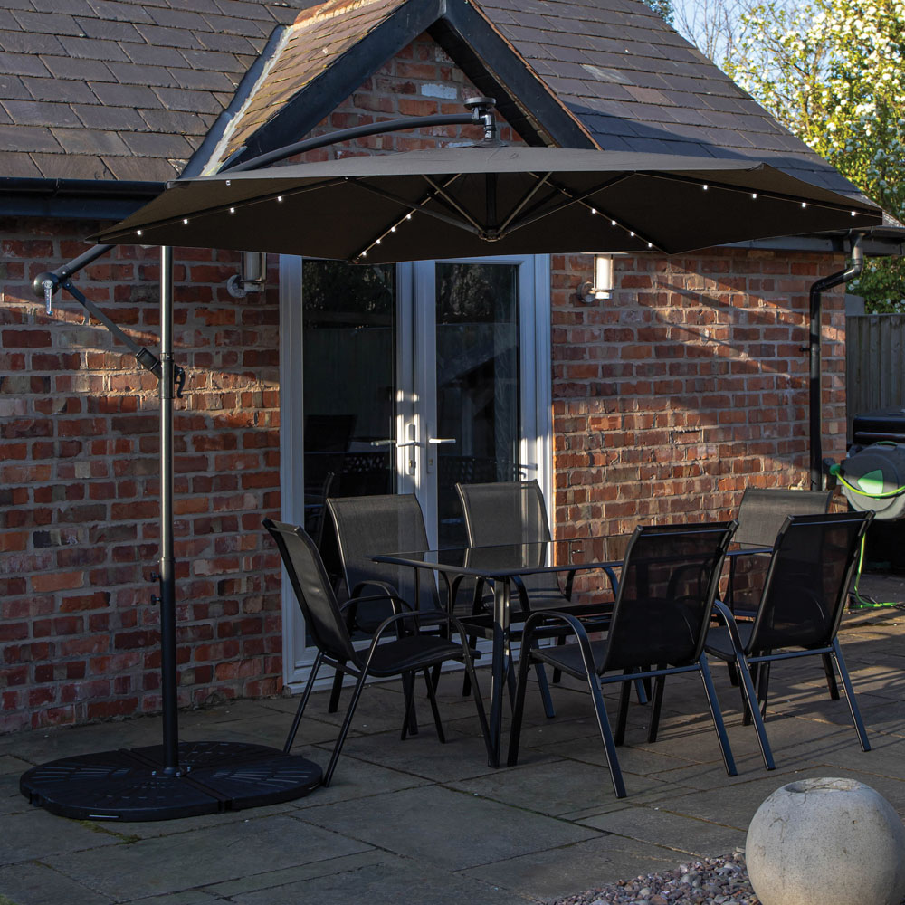 Samuel Alexander 6 Seater Glass Top Outdoor Dining Set with Black Banana Lit Parasol and Base Image 1