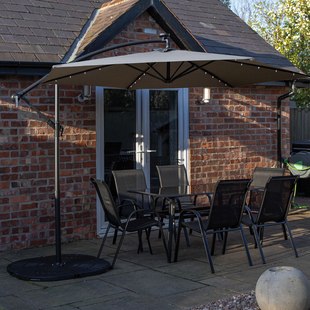 Samuel Alexander 6 Seater Glass Top Outdoor Dining Set with Grey Banana Lit Parasol and Base Image 1