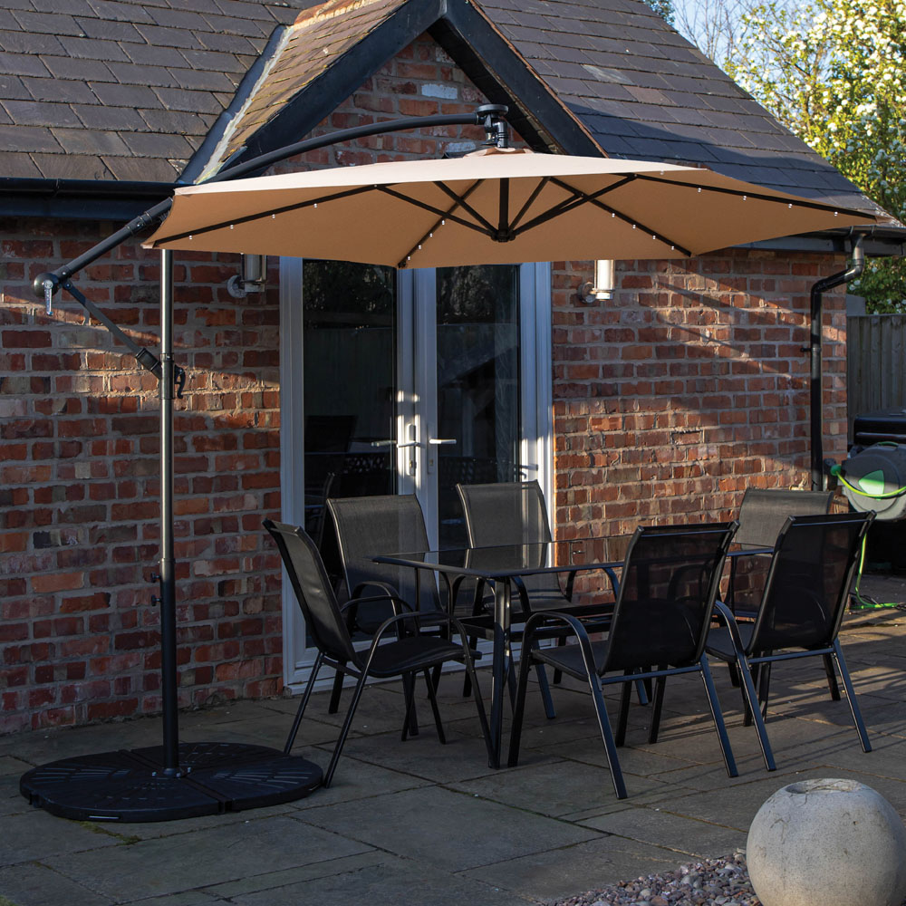Samuel Alexander 6 Seater Glass Top Outdoor Dining Set with Beige Banana Lit Parasol and Base Image 1