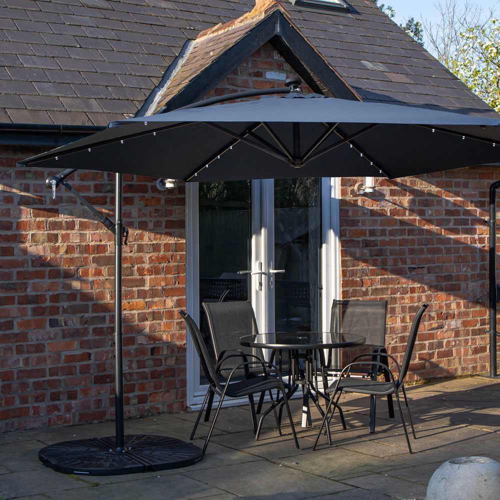 Samuel Alexander 4 Seater Glass Top Stackable Dining Set with Blue Banana Lit Parasol and Base Image 1