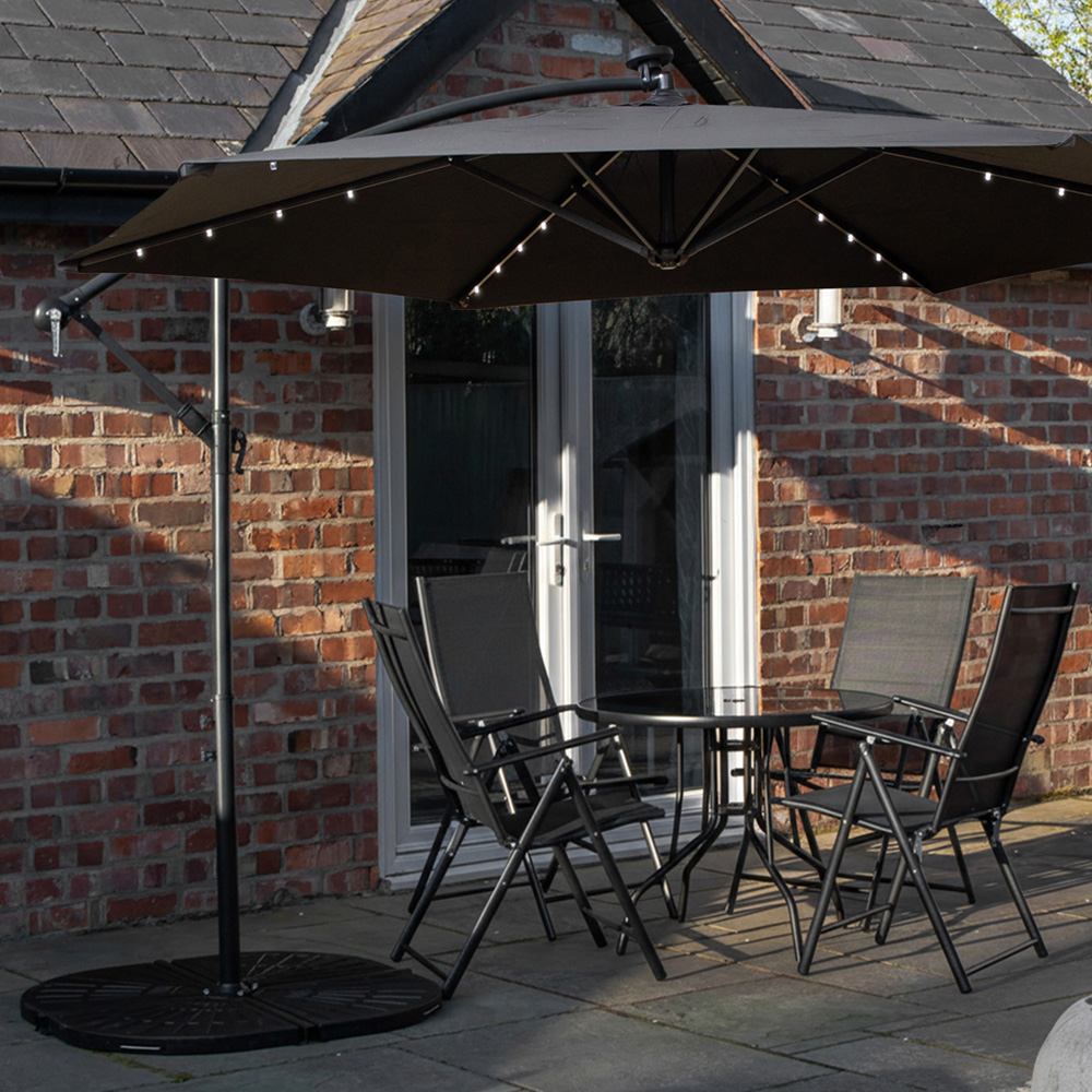 Samuel Alexander 4 Seater Glass Top Foldable Dining Set with Black Banana Lit Parasol and Base Image 1