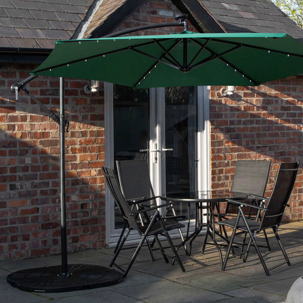 Samuel Alexander 4 Seater Glass Top Foldable Dining Set with Green Banana Lit Parasol and Base Image 1