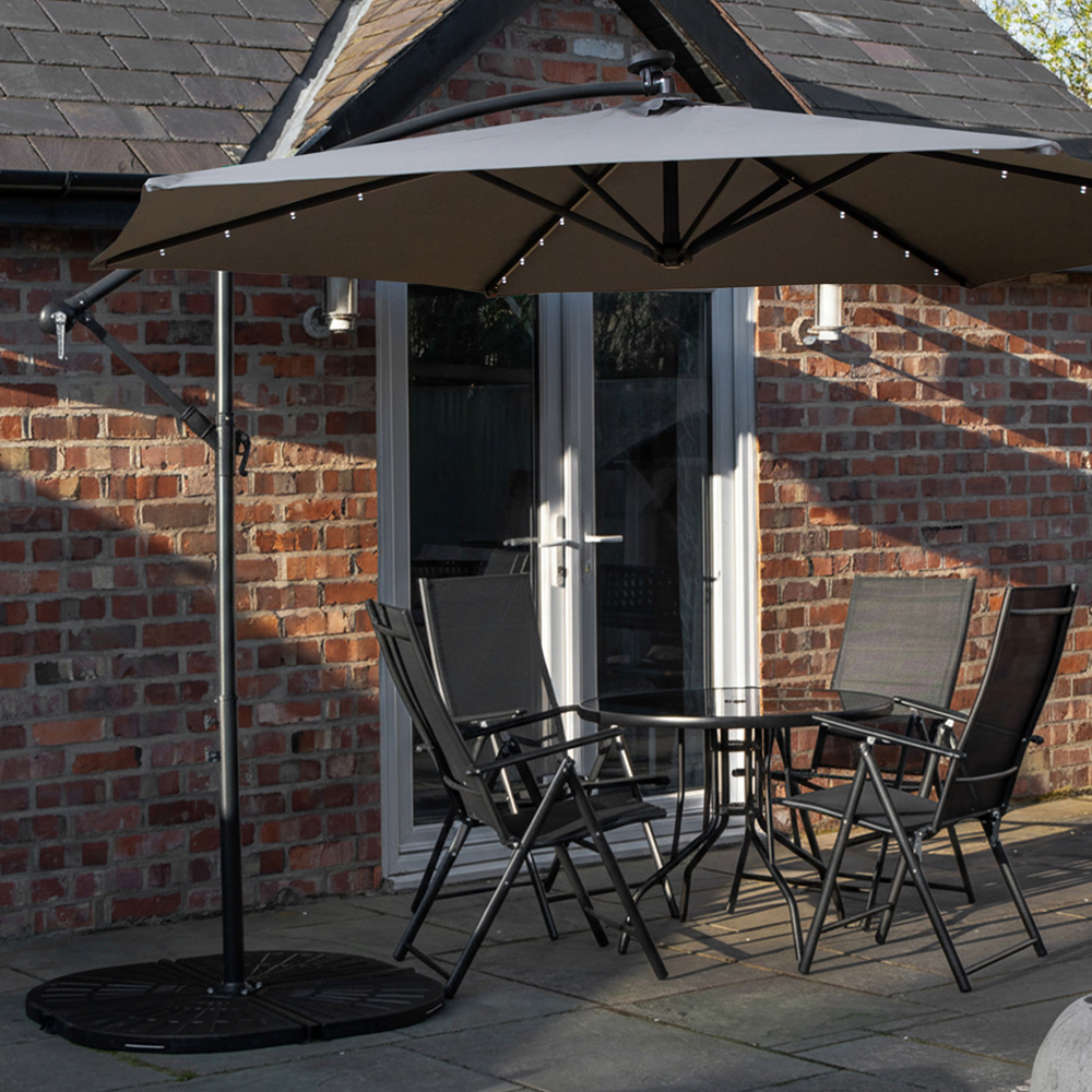 Samuel Alexander 4 Seater Glass Top Foldable Dining Set with Grey Banana Lit Parasol and Base Image 1