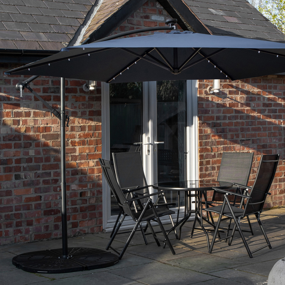 Samuel Alexander 4 Seater Glass Top Foldable Dining Set with Blue Banana Lit Parasol and Base Image 1