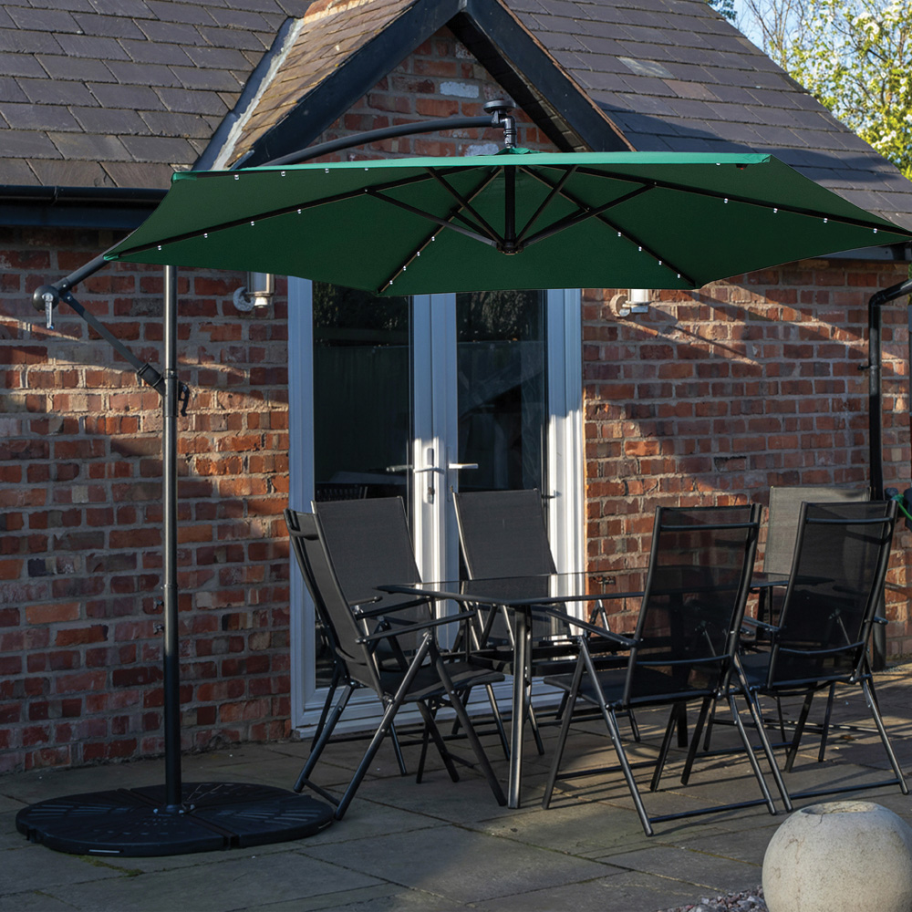 Samuel Alexander 6 Seater Glass Top Outdoor Dining Set with Green Banana Lit Parasol and Base Image 1