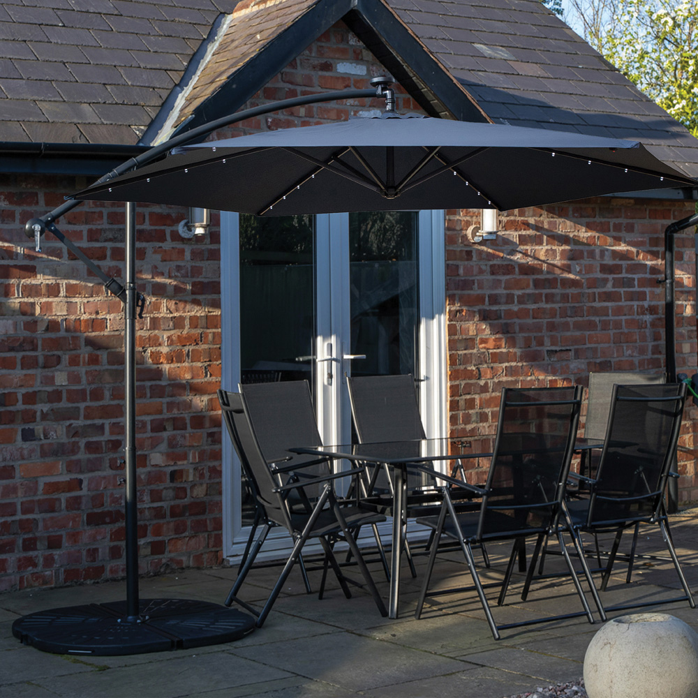 Samuel Alexander 6 Seater Glass Top Outdoor Dining Set with Blue Banana Lit Parasol and Base Image 1