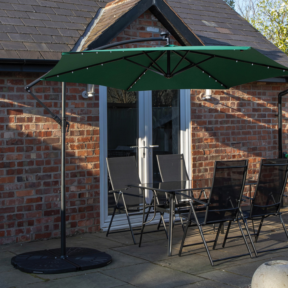 Samuel Alexander 4 Seater Glass Top Outdoor Dining Set with Green Banana Lit Parasol and Base Image 1