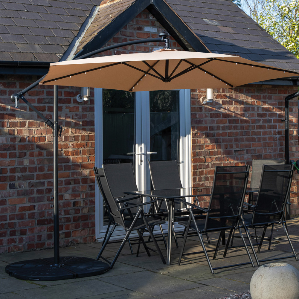 Samuel Alexander 6 Seater Glass Top Outdoor Dining Set with Beige Banana Lit Parasol and Base Image 1