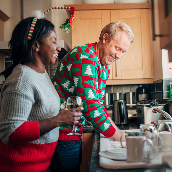 Man and woman cleaning up in kitchen Man and woman cleaning up in kitchen